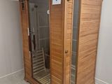 a wooden saunat in the corner of a bathroom
