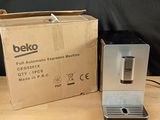 a coffee machine sitting on a table next to a box