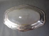 an antique silver plate on a table with a tag on it