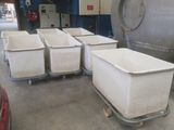 four bins sitting on a dolly in a warehouse