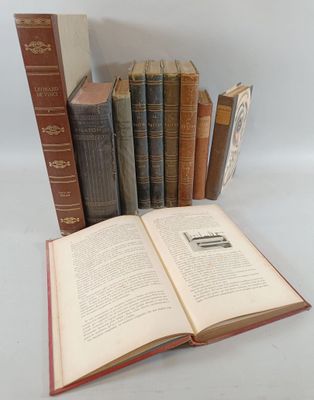 several old books are stacked on top of each other on a table
