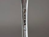 a silver spoon with a fork on it on a table