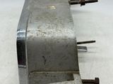 a metal object that is sitting on a white surface