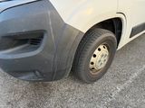 a white van that has a flat tire on the side of the road