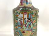 a vase with a painting on it sitting on a table
