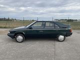 an image of a green car parked in a parking lot