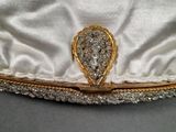 a close up of a hat with a broochet on it