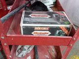 a red work bench with tools in it and a box on top of it