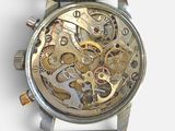 a close up of a watch with a black strap on it