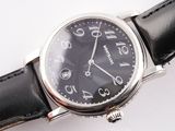 a close up of a wrist watch on a white surface