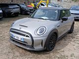 a silver mini cooper parked in a parking lot
