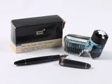 a pen and a brush sitting next to a box of ink