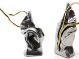 two silver and gold earrings with a tree on them