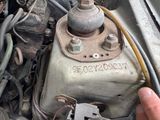 a close up of a person ' s hand holding an old car engine