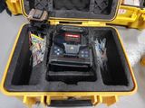 a yellow case with a tool in it on a table