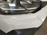 a close up of a car ' s headlight with the hood down