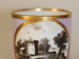 a cup with a picture on it sitting on a table