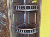 a wooden cabinet with a glass door on the inside