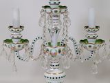 a white candelab with green and white designs on it