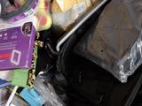 a black bag full of items sitting on a bed
