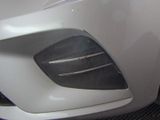 a close up of the front bumper of a white car