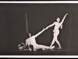 an old black and white photo of a man and a woman in a dance pose