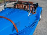 an image of a blue sports car parked on the side of the road