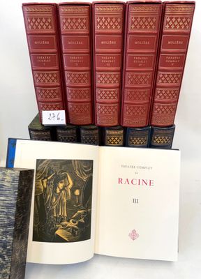 several books are stacked on top of each other on a table