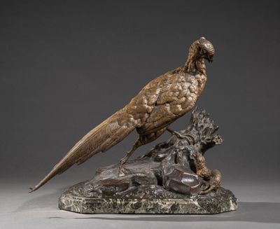 bronze sculpture of a pheasant and a lion on a marble base