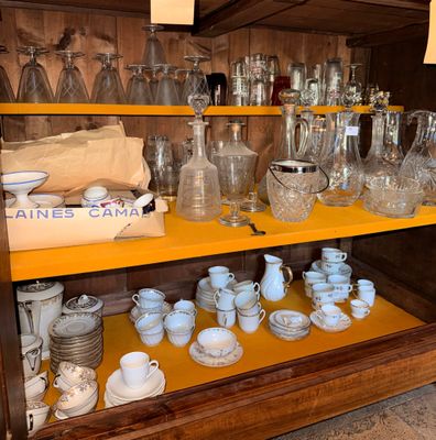 many different types of glassware on the shelves