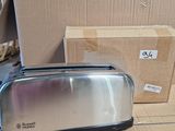 a toaster sitting on a table next to a box