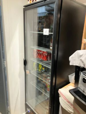 a refrigerator that is next to a counter in a kitchen