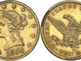 a gold coin with an eagle on the front and a woman ' s head on the back