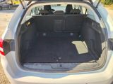 the back of a car with its trunk open in a parking lot