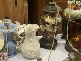many different vases on a table with a white table cloth