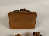 three figurines that are sitting next to a box