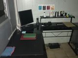 a desk with a laptop and a monitor on it
