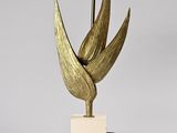 gold leaf table lamp with a white base and a gold lamp shade