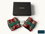 chanel bow tie in red, green, and white with a black box