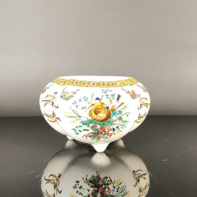 a white bowl with a floral design on it on a table