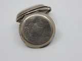 an antique silver pocket watch with a coin in the middle
