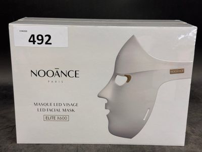 a box with a white mask on it on a table