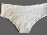 a close up of a white underwear briefs on a gray background