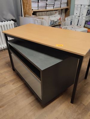 a desk with a drawer on top of it in a room