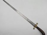 a close up of a knife with a wooden handle on a white surface