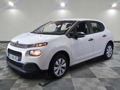 the white citrole is parked on a checkered tile floor