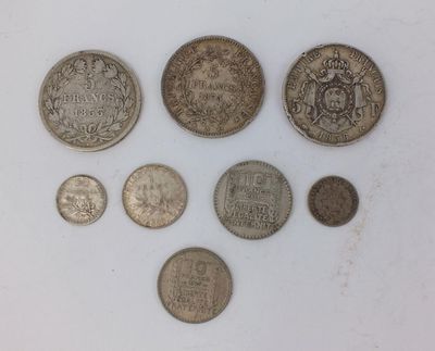 six different british coins on a white surface