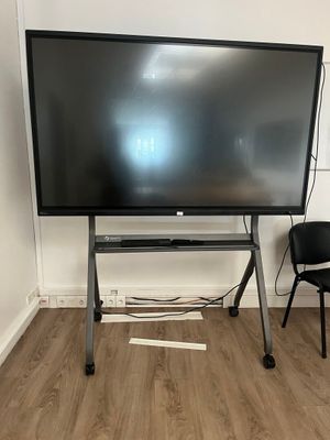 a flat screen tv sitting on a stand in the corner of a room