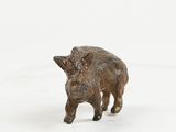 a small figurine of a boar standing in the snow