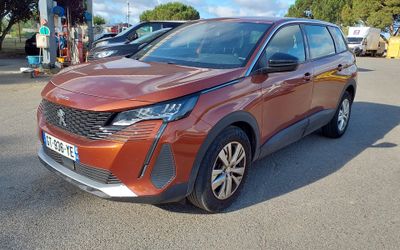 the orange car is parked in the parking lot next to other cars